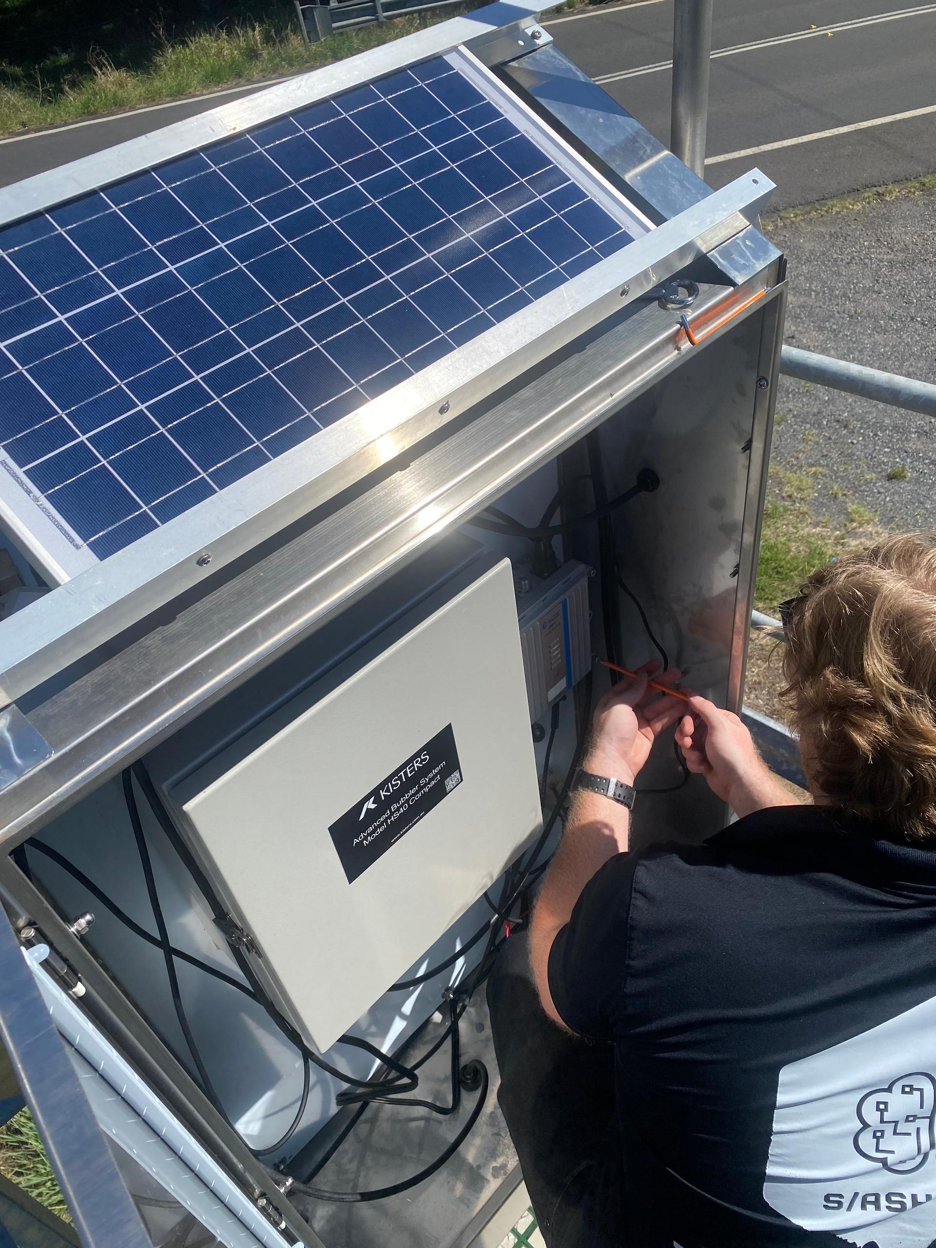 Technician commissioning field hardware on site