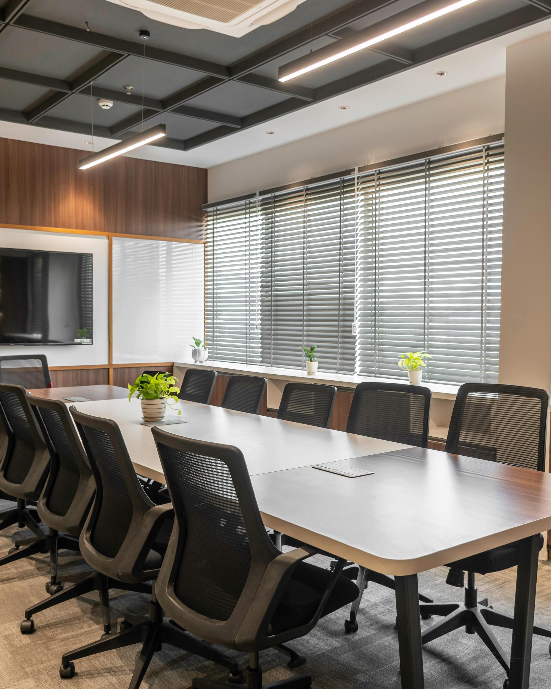 A meeting room table with a proposal document open and a pen resting across it, unsigned